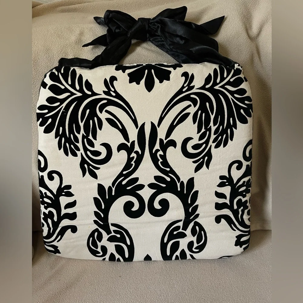 Chic Black and Cream padded chair covers with black satin ties.